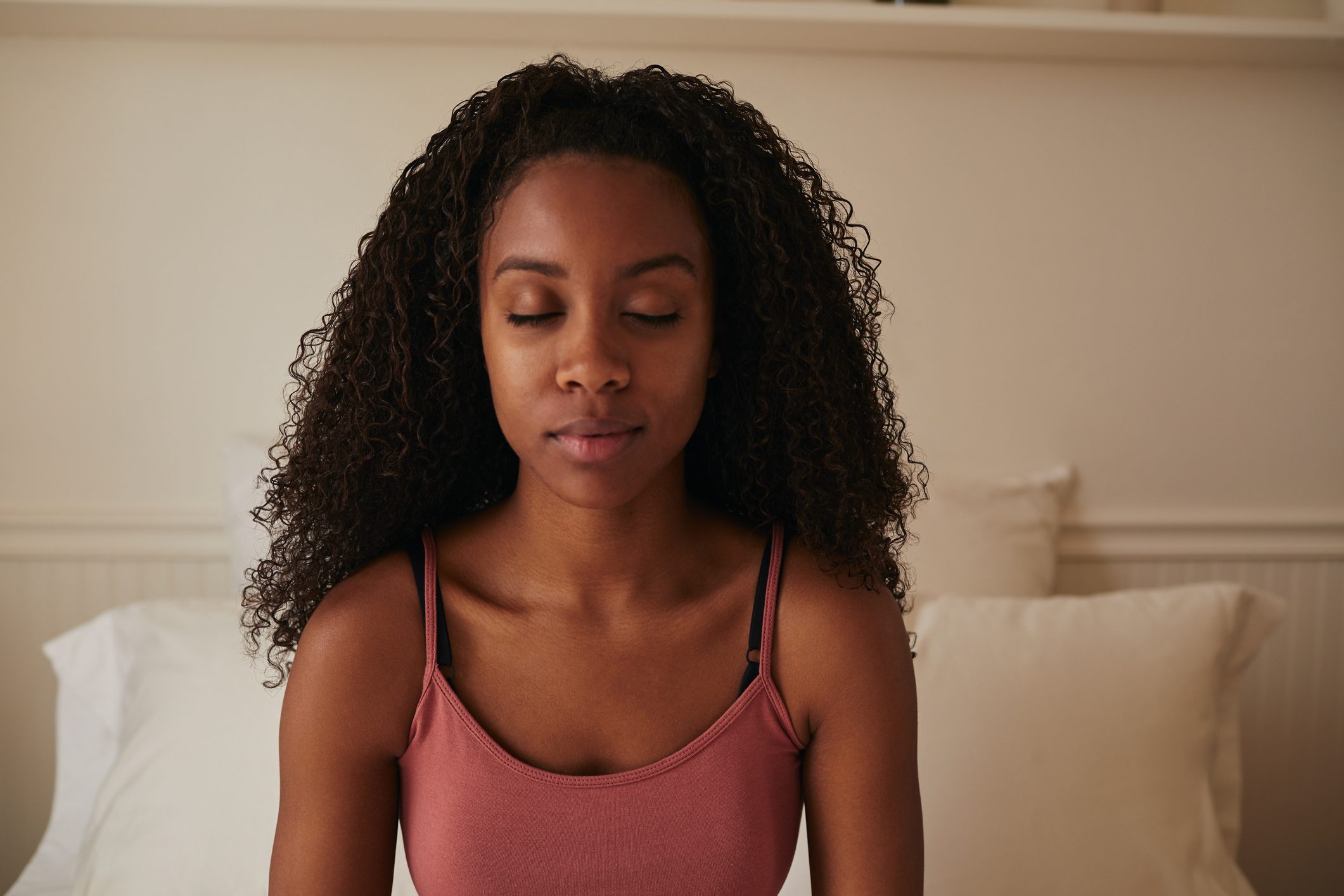 woman meditating in bed