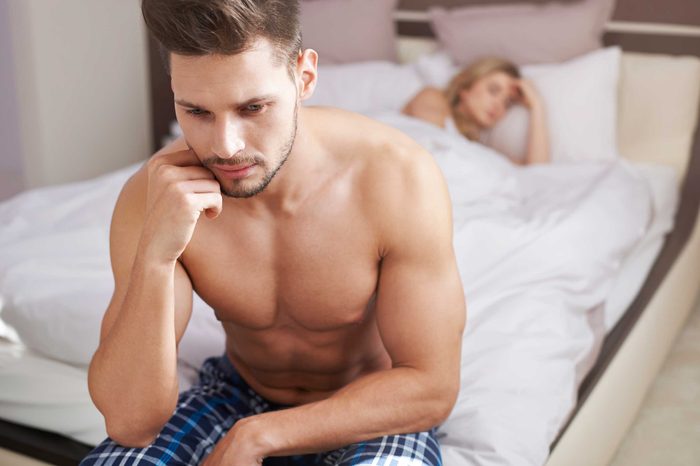 Man turned away from woman in bed