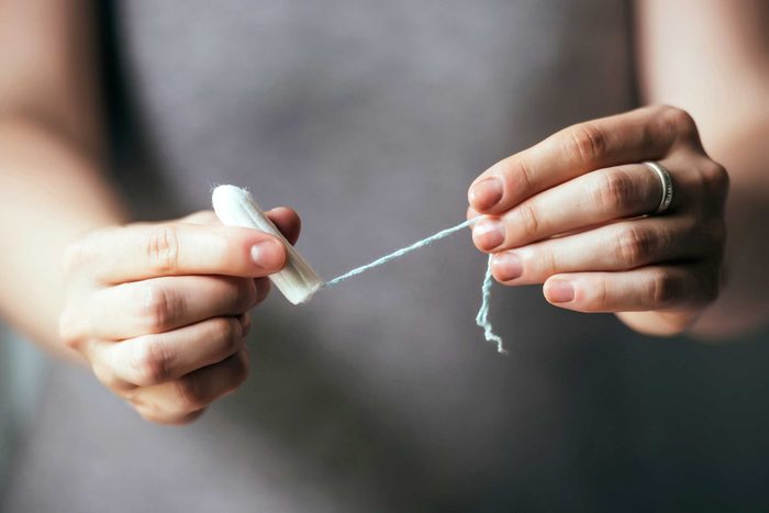 woman holding a tampon