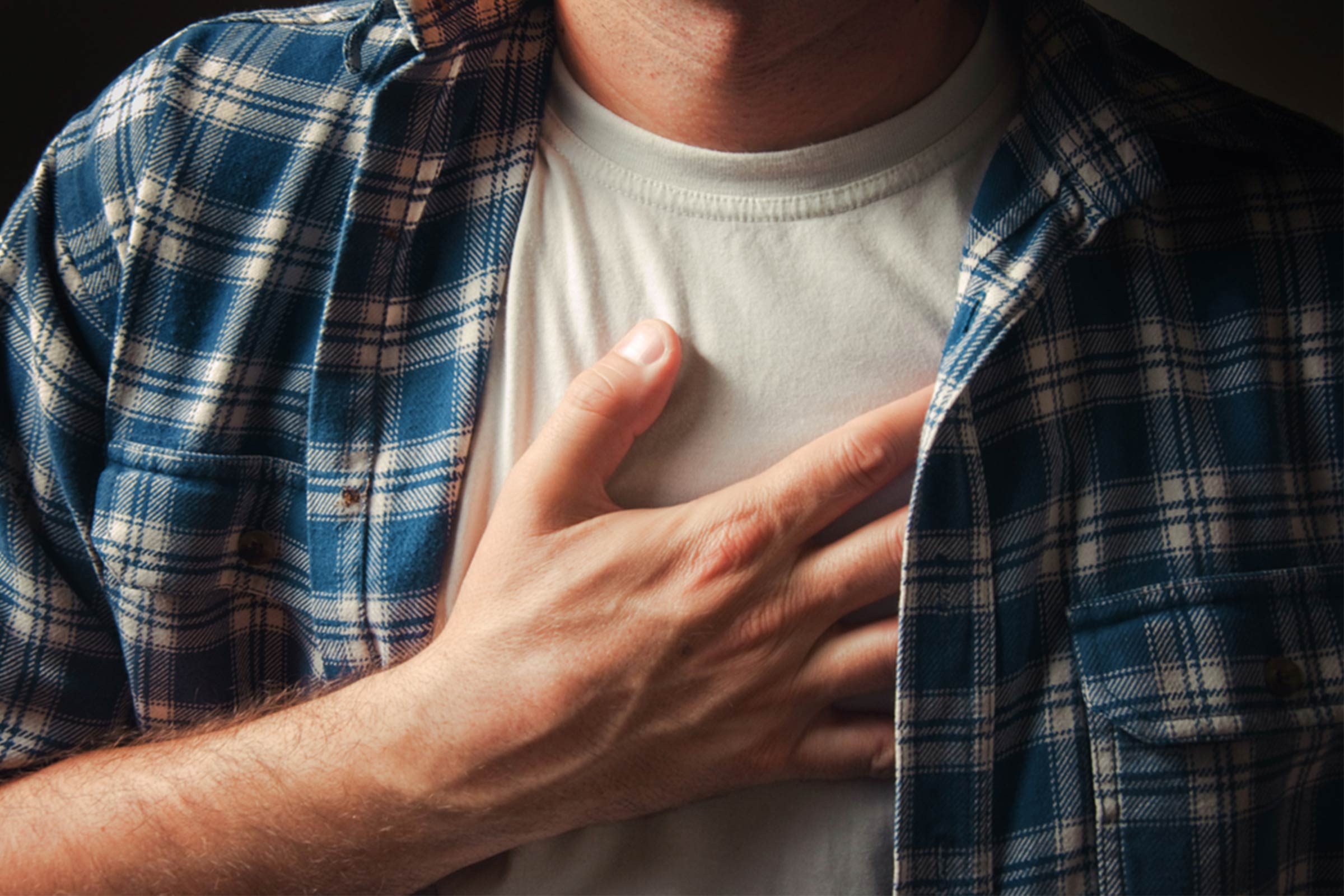 man grasping his chest