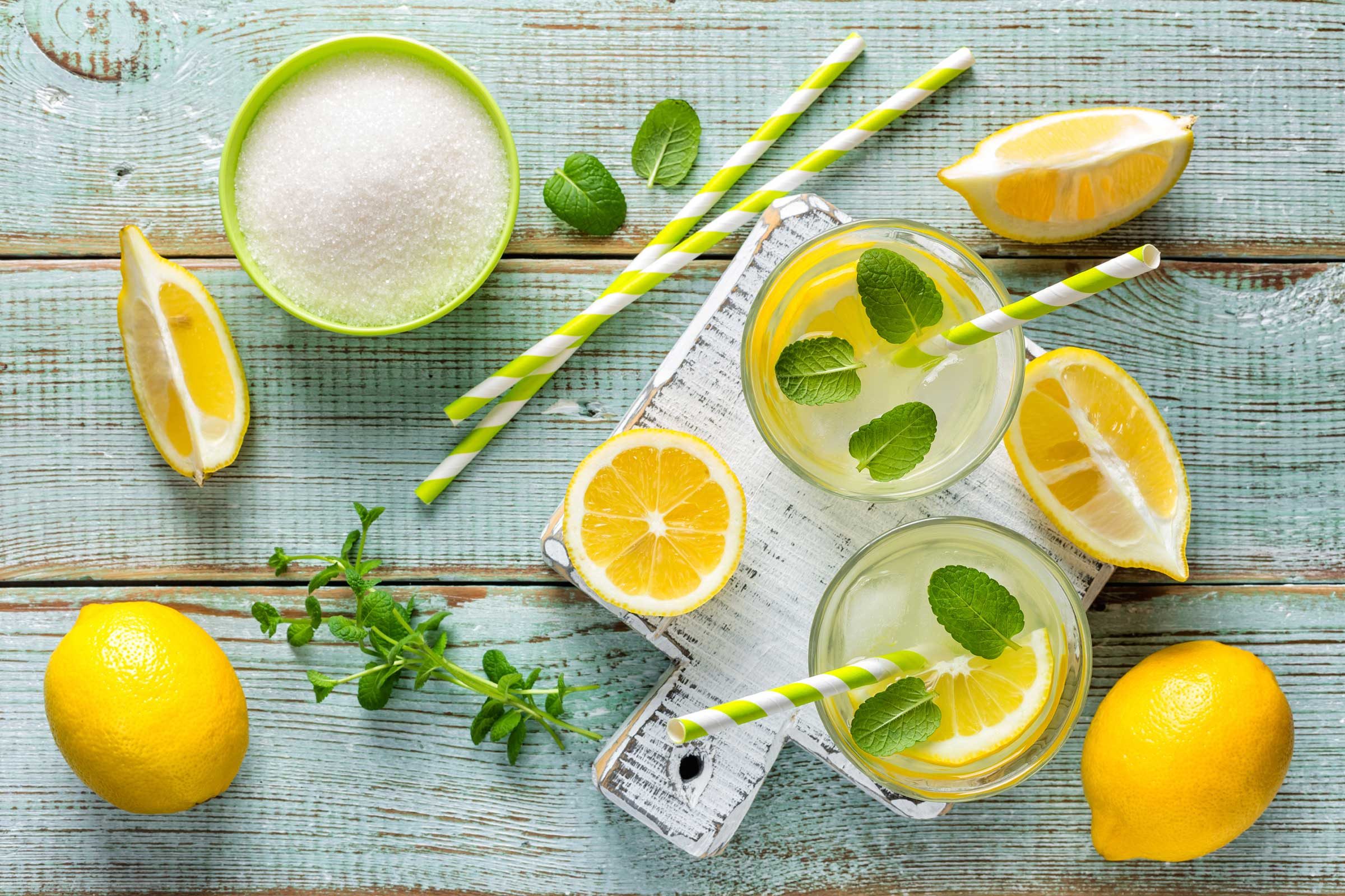 scattered lemons and a bowl of sugar