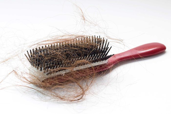 hair brush with lots of hair in it
