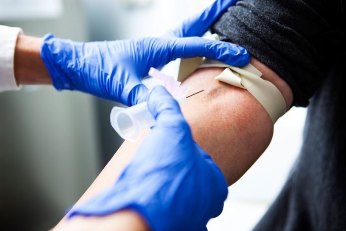 person getting needle inserted into vein