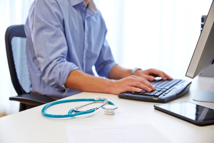 man at computer with stethoscope