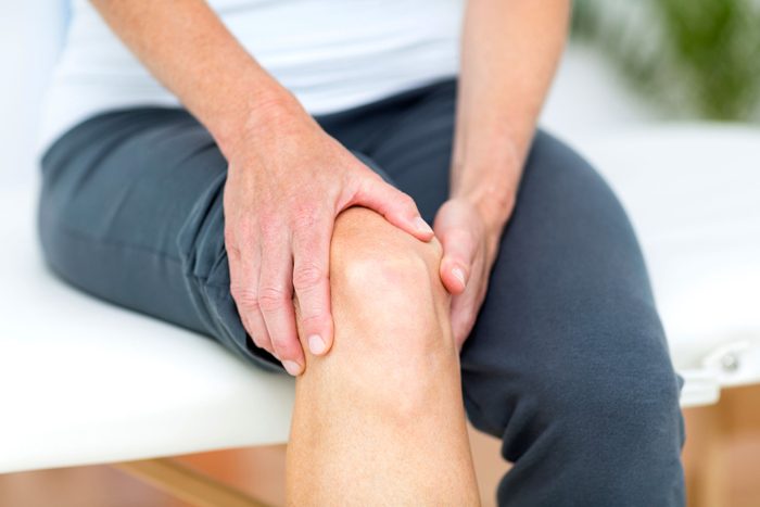 sitting person holding knee