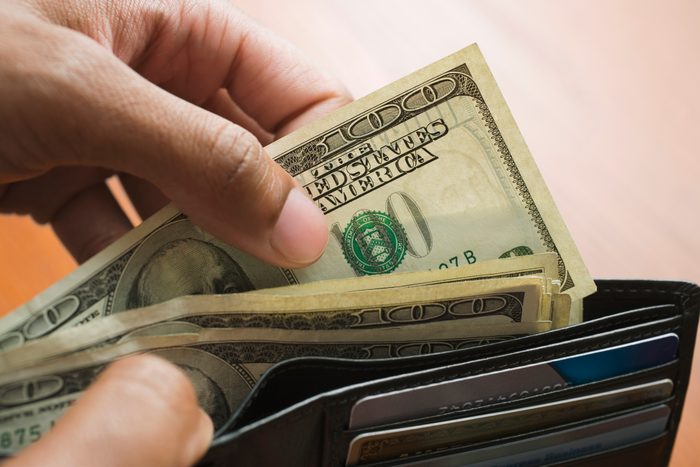 close up of taking money out of wallet