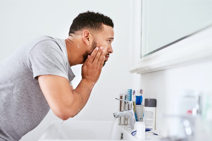 man washing his face
