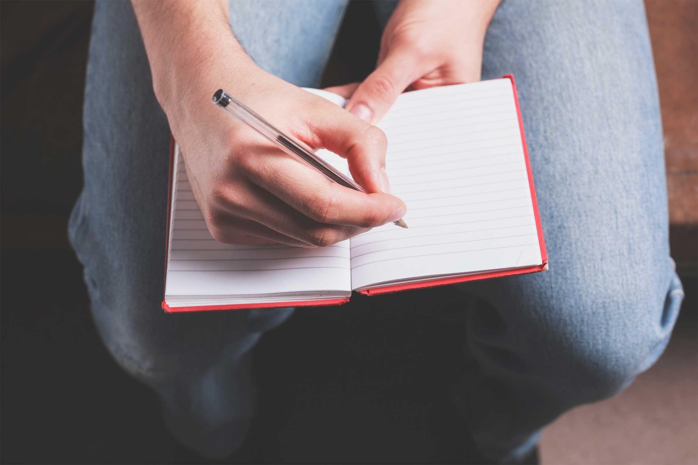 person writing in a journal