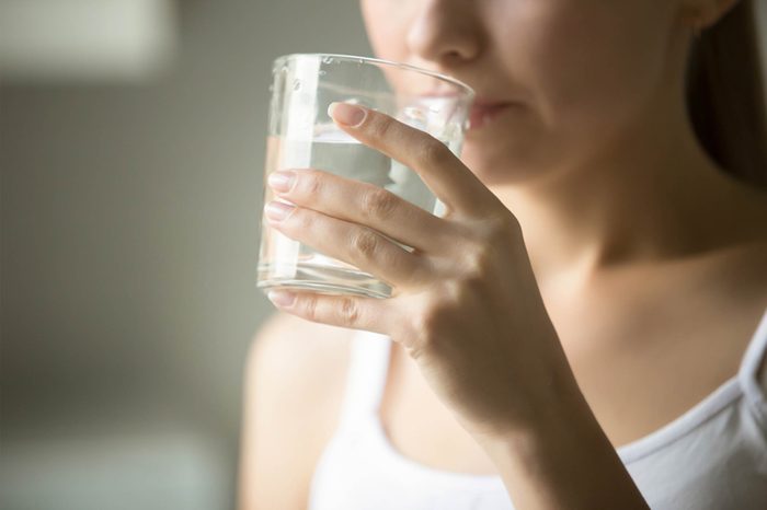 Woman sipping water.