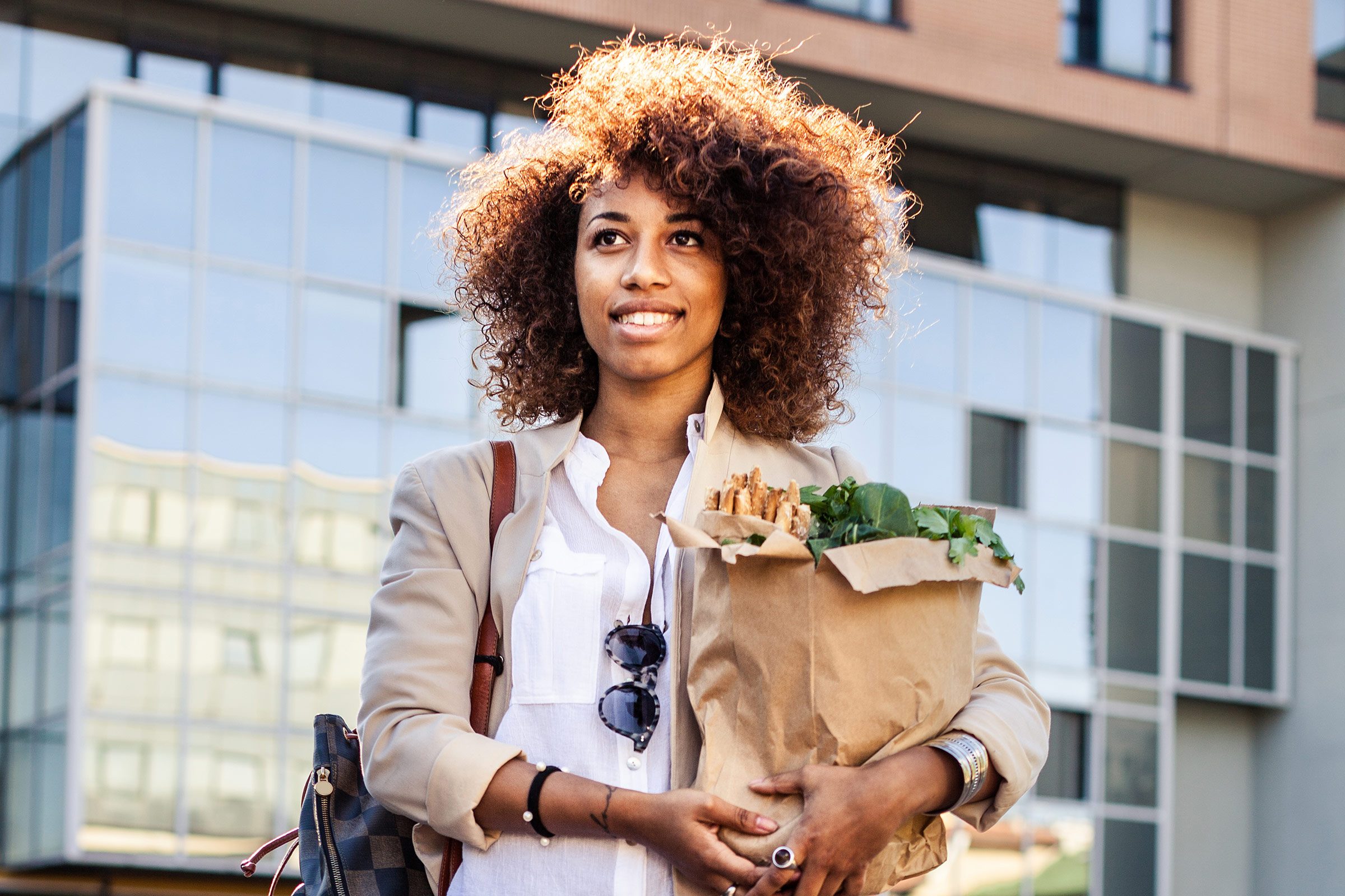 black woman carrying groceries