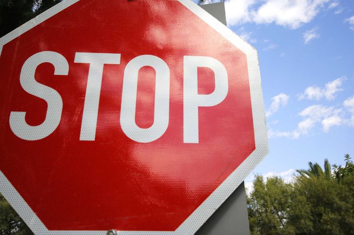 Red stop sign on a post.