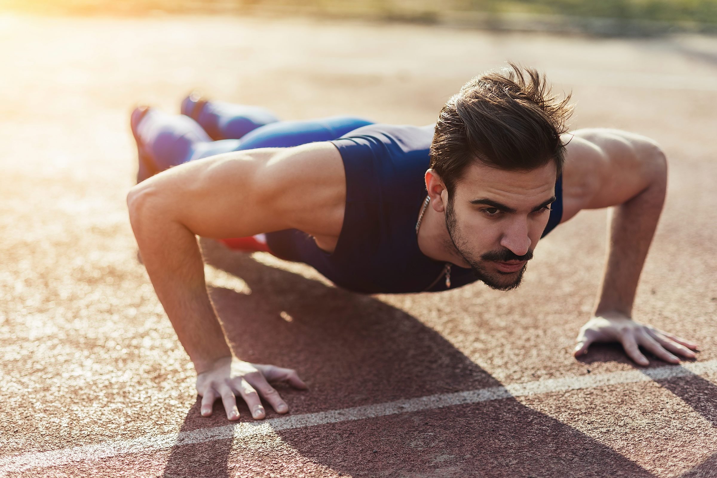 man outdoors doing pushups