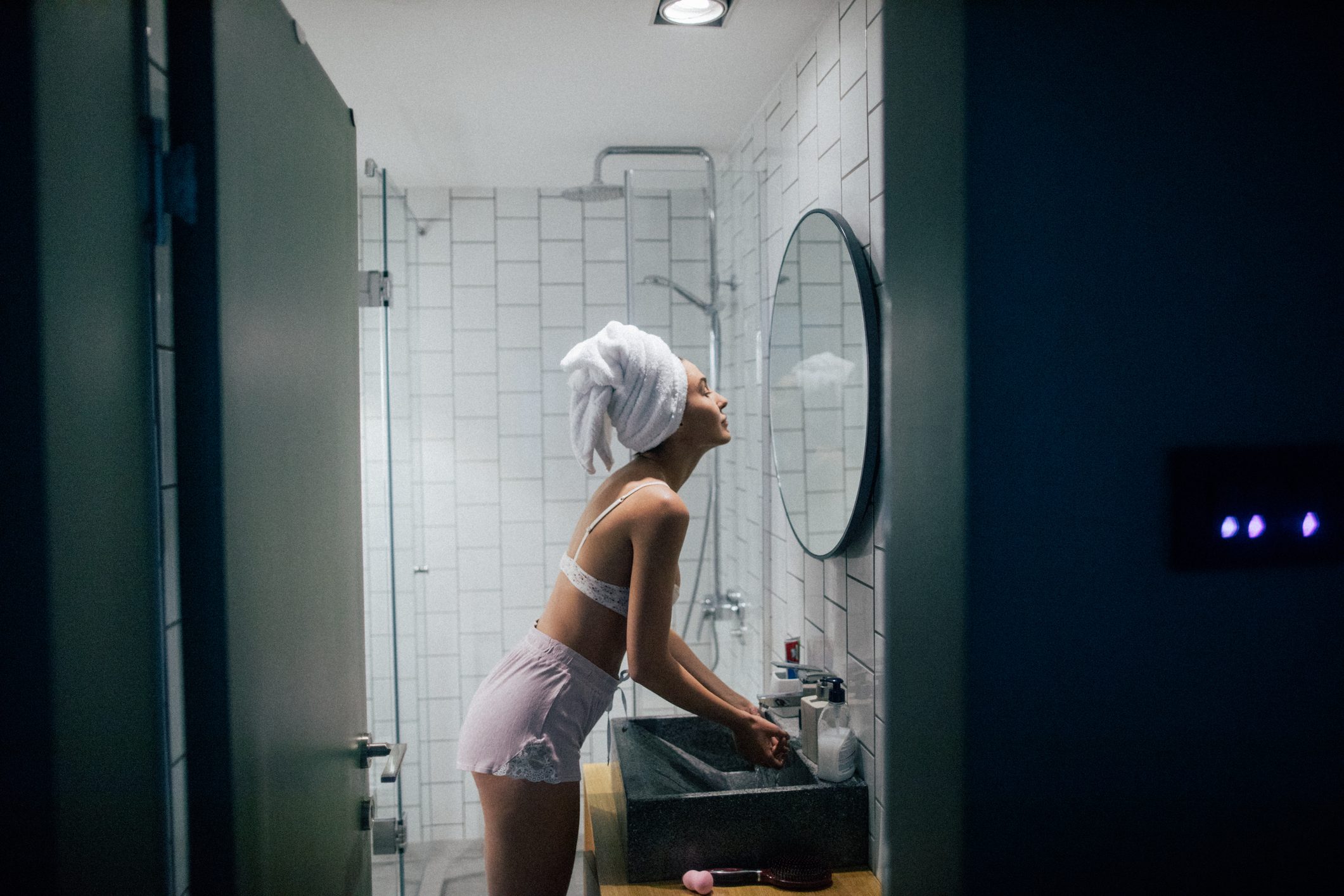 woman in the bathroom at night after taking a shower