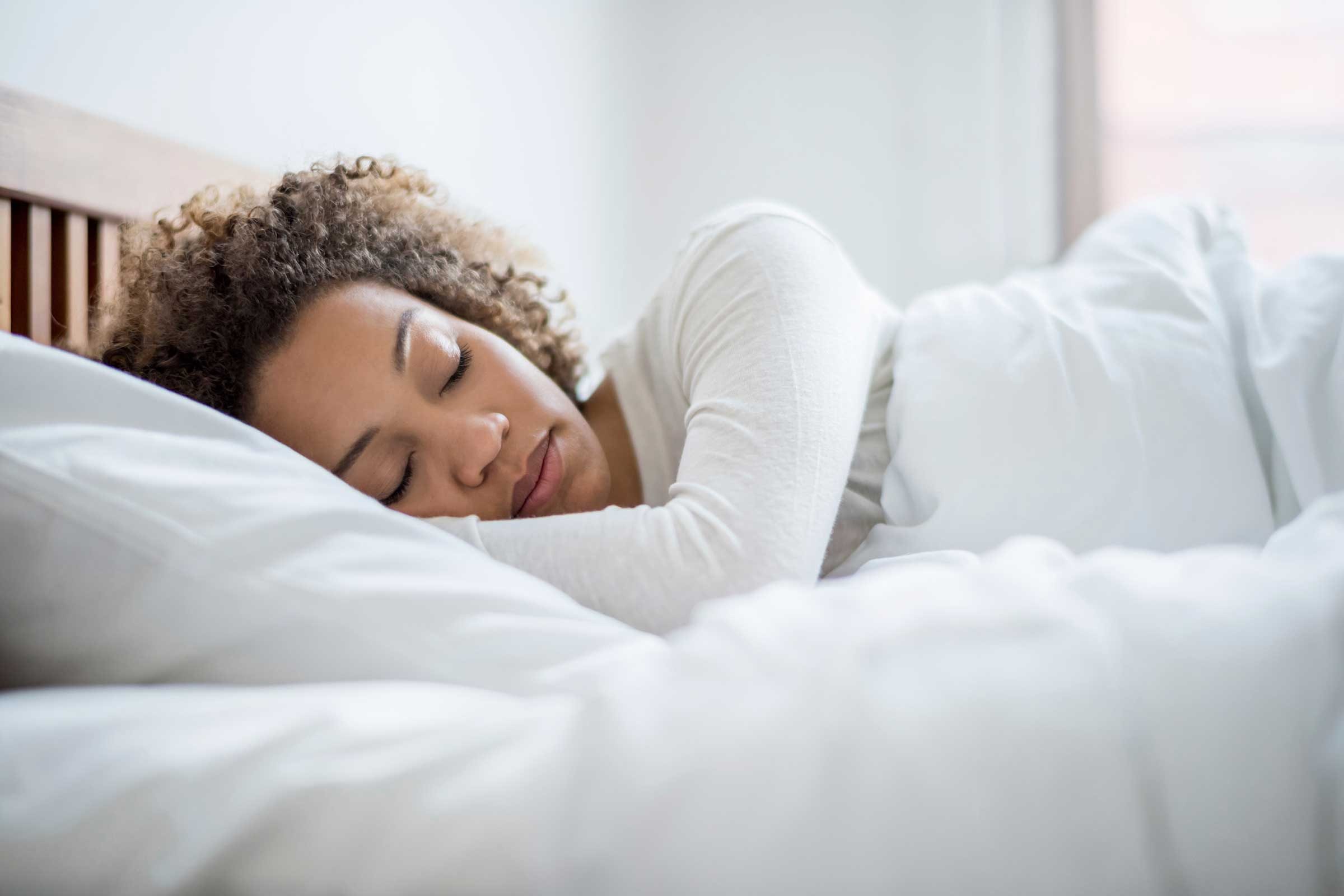 Woman sleeping in bed in the morning.
