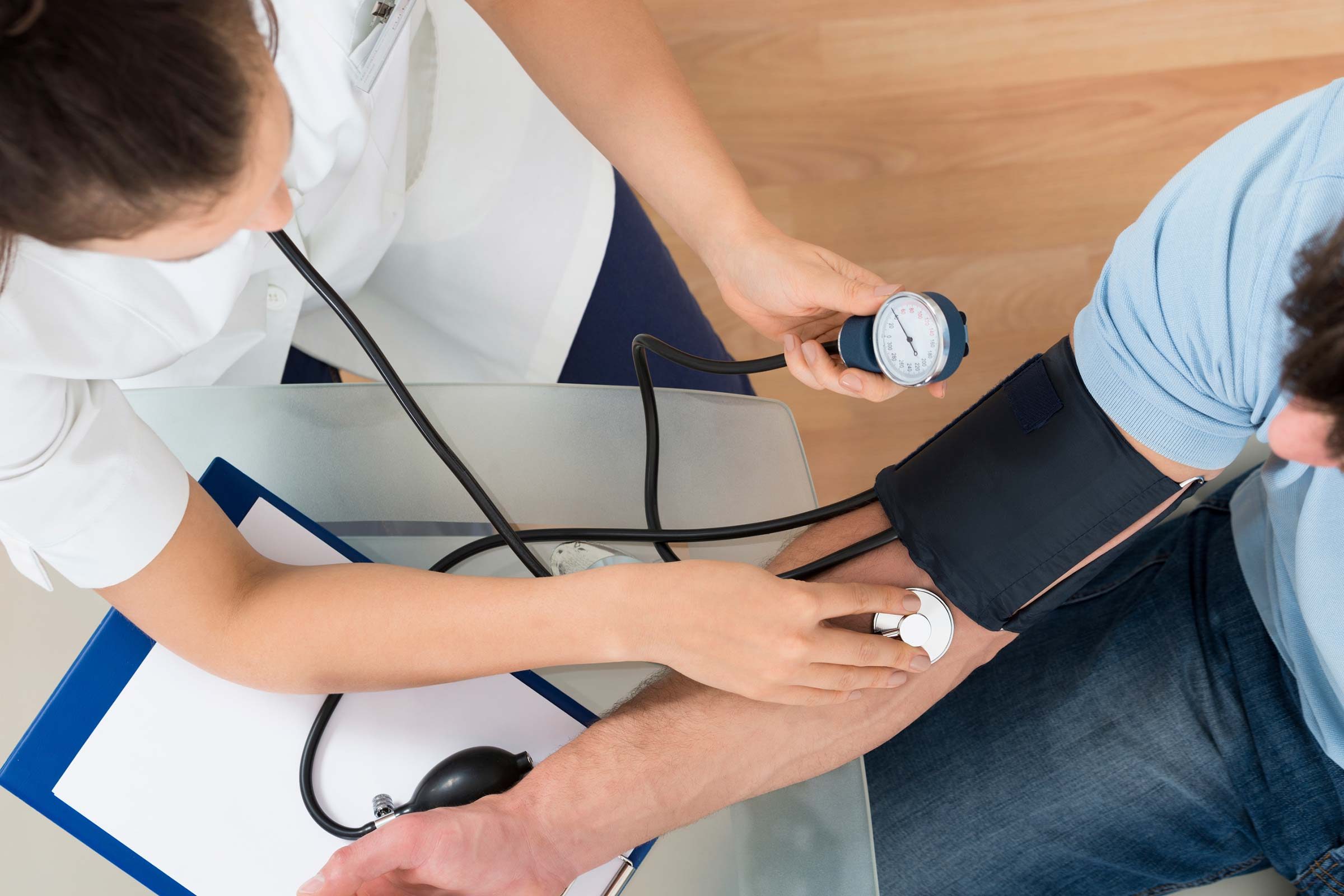 nurse checking a patients blood pressure