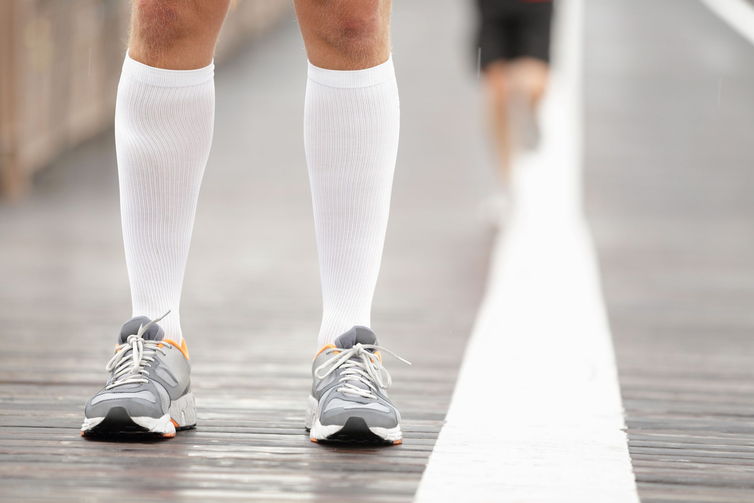 person wearing compression socks and sneakers