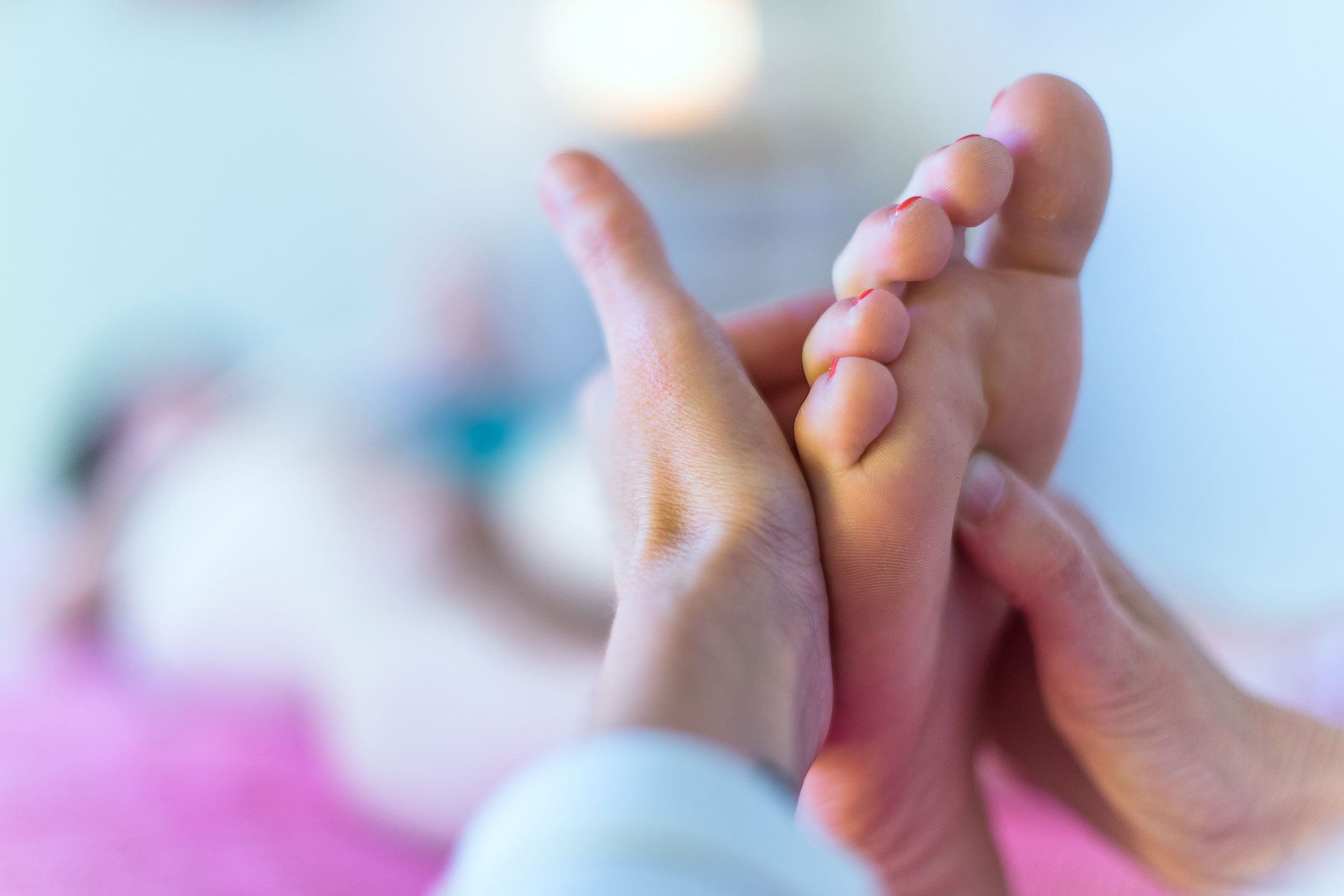 hands massaging feet