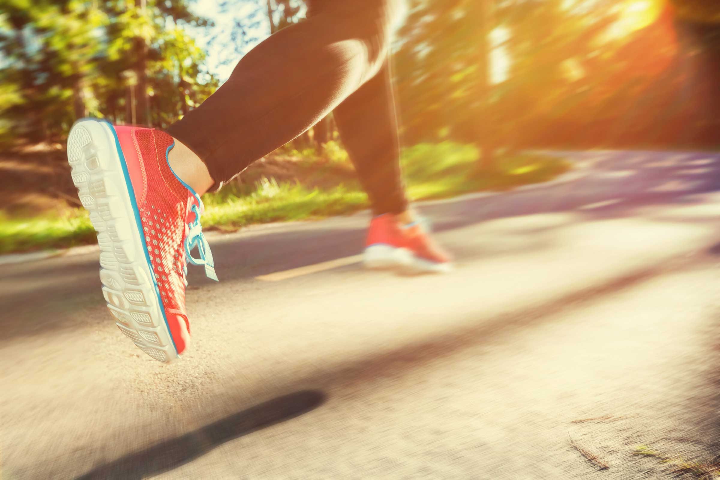 Woman jogger running on a trail.