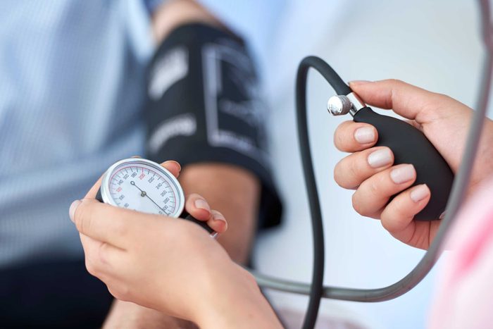 doctor checking blood pressure of patient