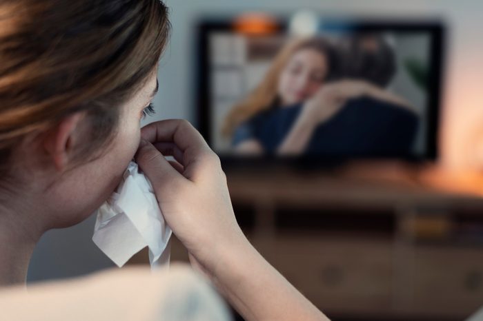 woman crying while watching sad movie crying and hormones