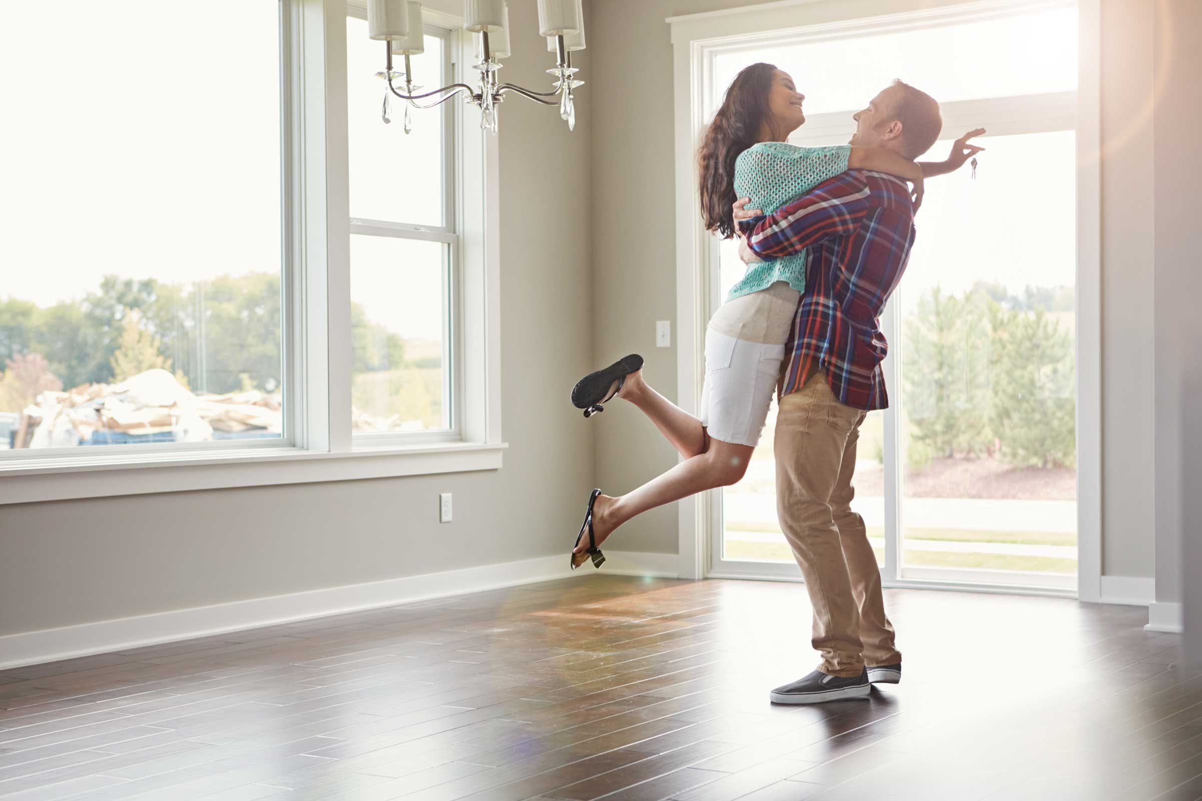 man lifting woman in embrace