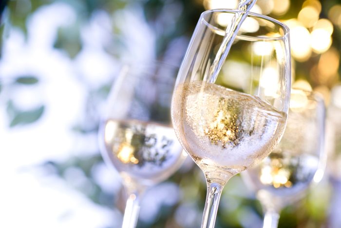 pouring glasses of white wine