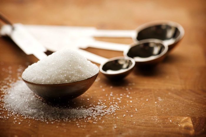 measuring spoons, one full of sugar