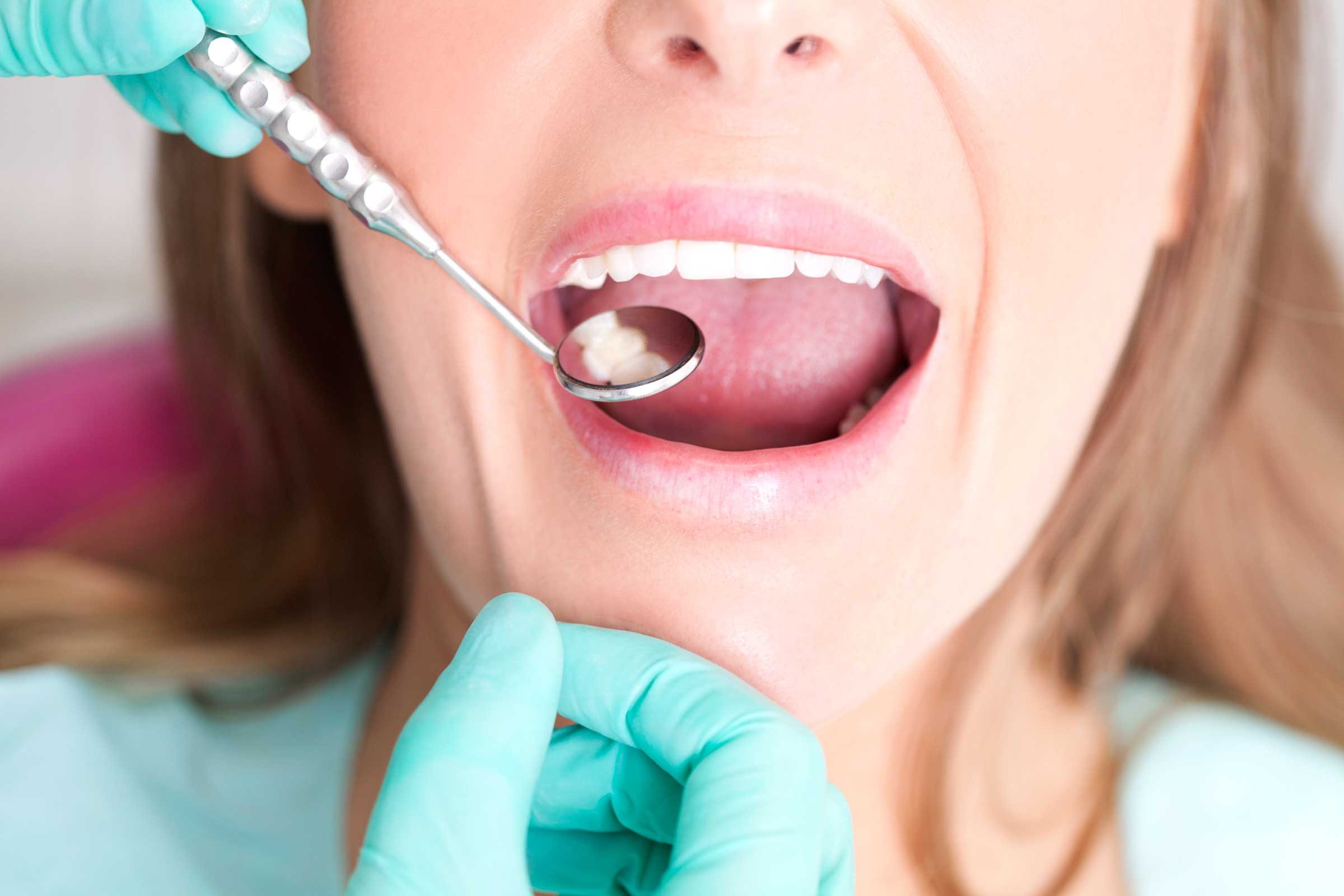 dentist examining woman's mouth