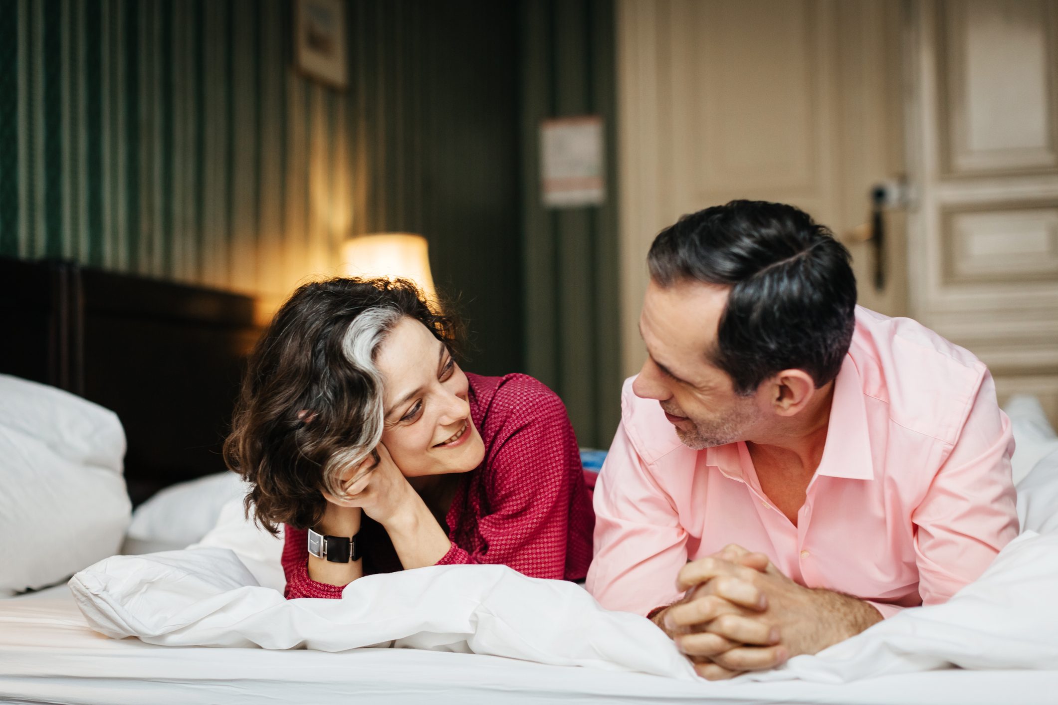 happy couple lying in bed