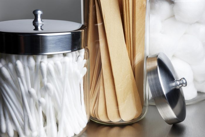 jars of cotton swabs and tongue depressors
