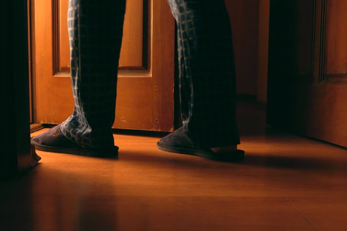 Adult man walks to a bathroom at the night elderly