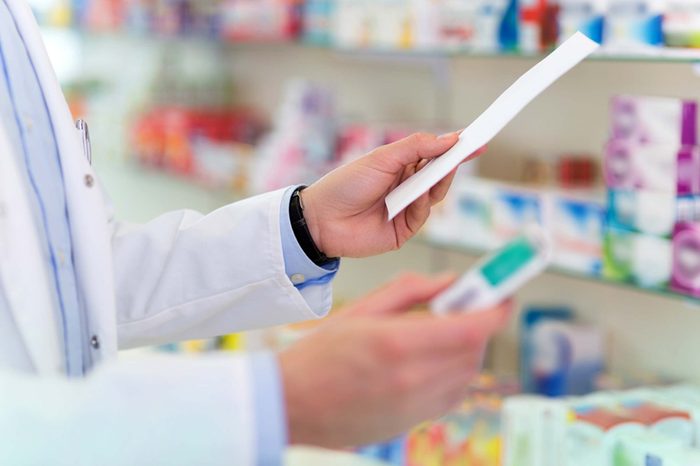 pharmacist looking at Rx