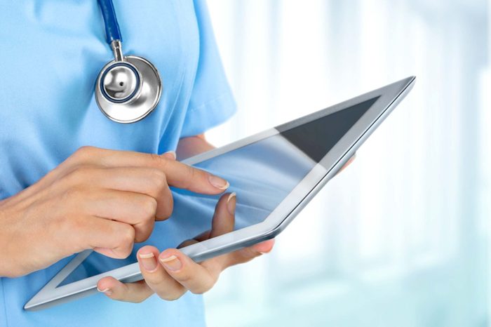 doctor typing on ipad