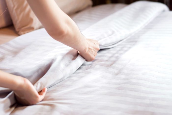 person making the bed
