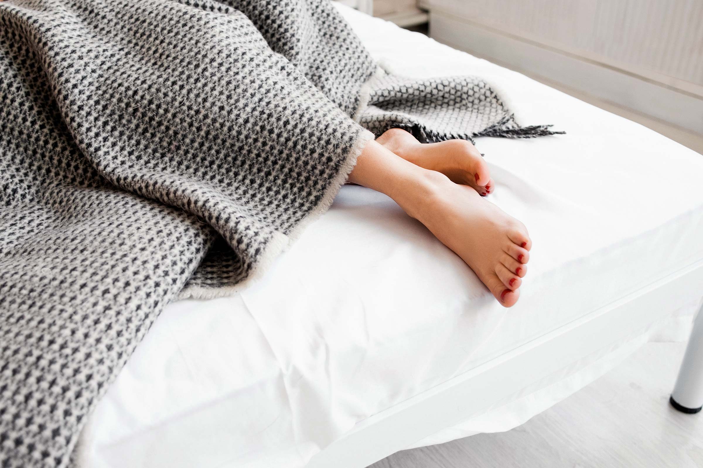 feet sticking out from blanket