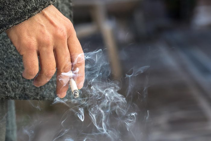 person holding cigarette