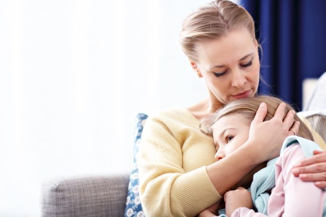 mother holding her sad daughter