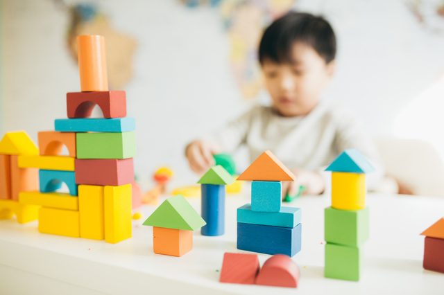 young boy playing with blocks