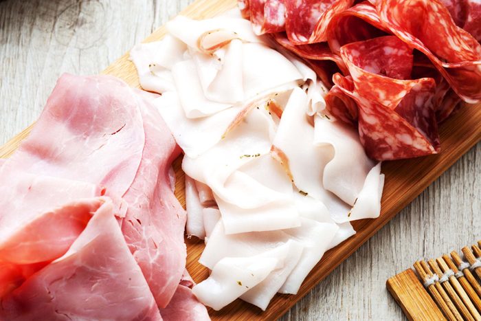 Variety of processed d eli meats on serving plate