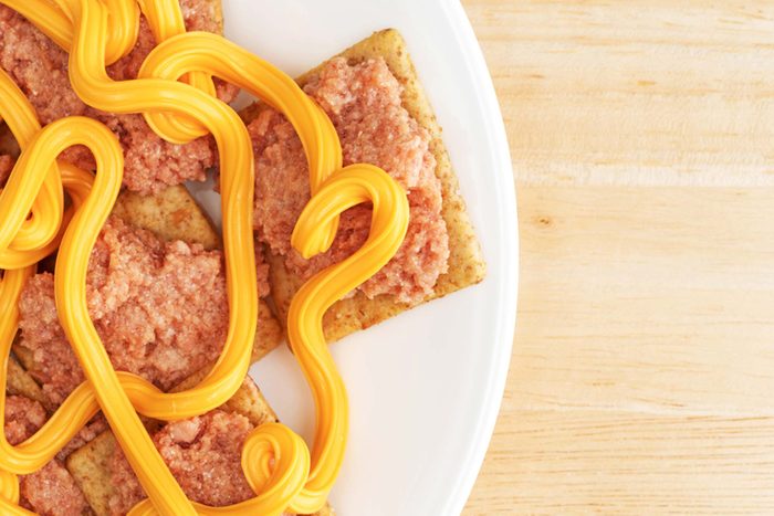 Crackers with streams of cheese wiz