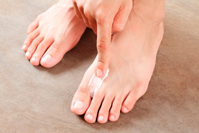rubbing cream between toes