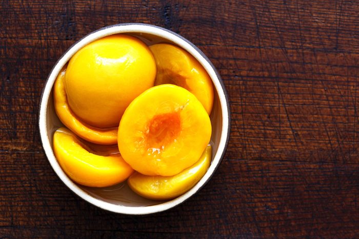 Bowl of peach halves taken from a can