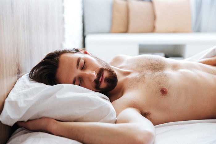 man asleep in bed