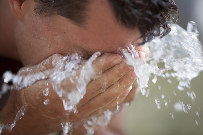 splashing face with cold water