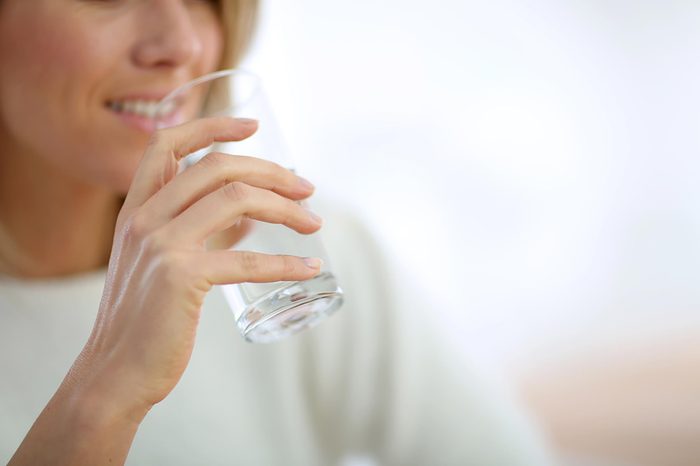 woman drinking a glass of water