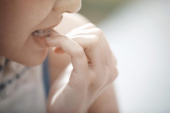 person biting fingernails