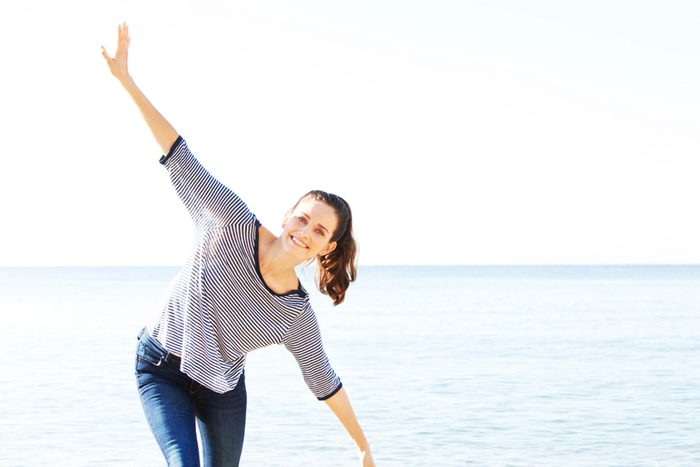 woman striking a silly pose at the beach