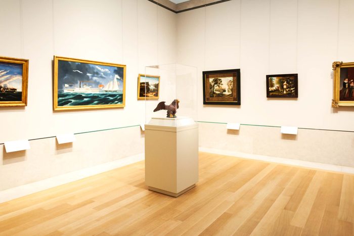 framed art on the walls in a museum gallery