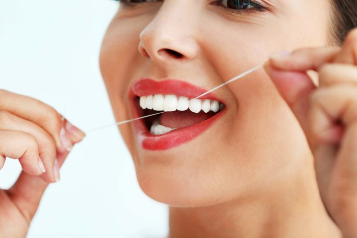 close up of woman flossing