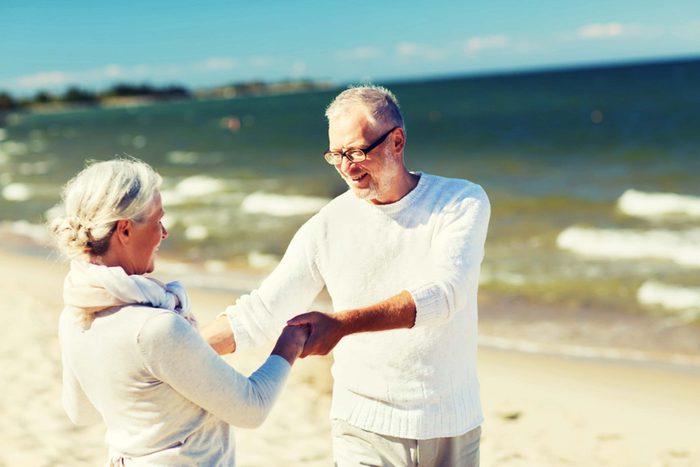 mature couple dancing on the beach